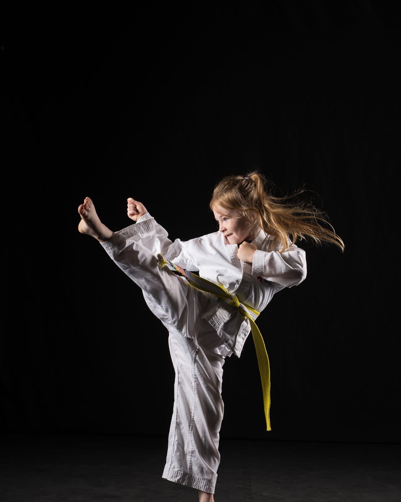 A TKD Kidz student landing a high kick at Apex Martial Arts, Evesham