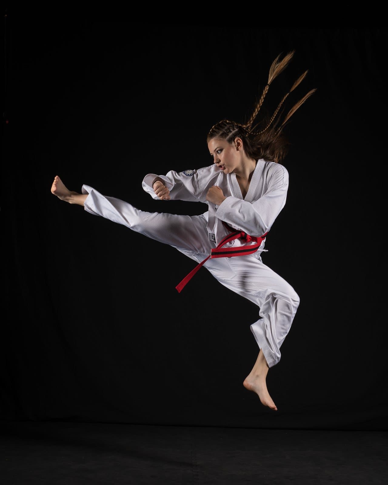 An adult Taekwon-Do student landing a side kick at Apex Martial Arts, Evesham