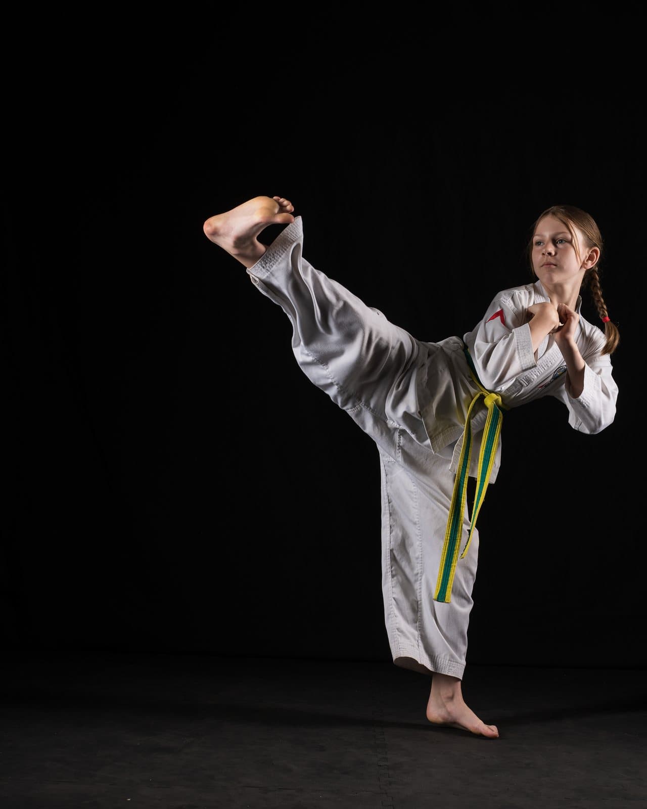 A TKD Juniors student landing a side kick at Apex Martial Arts, Evesham