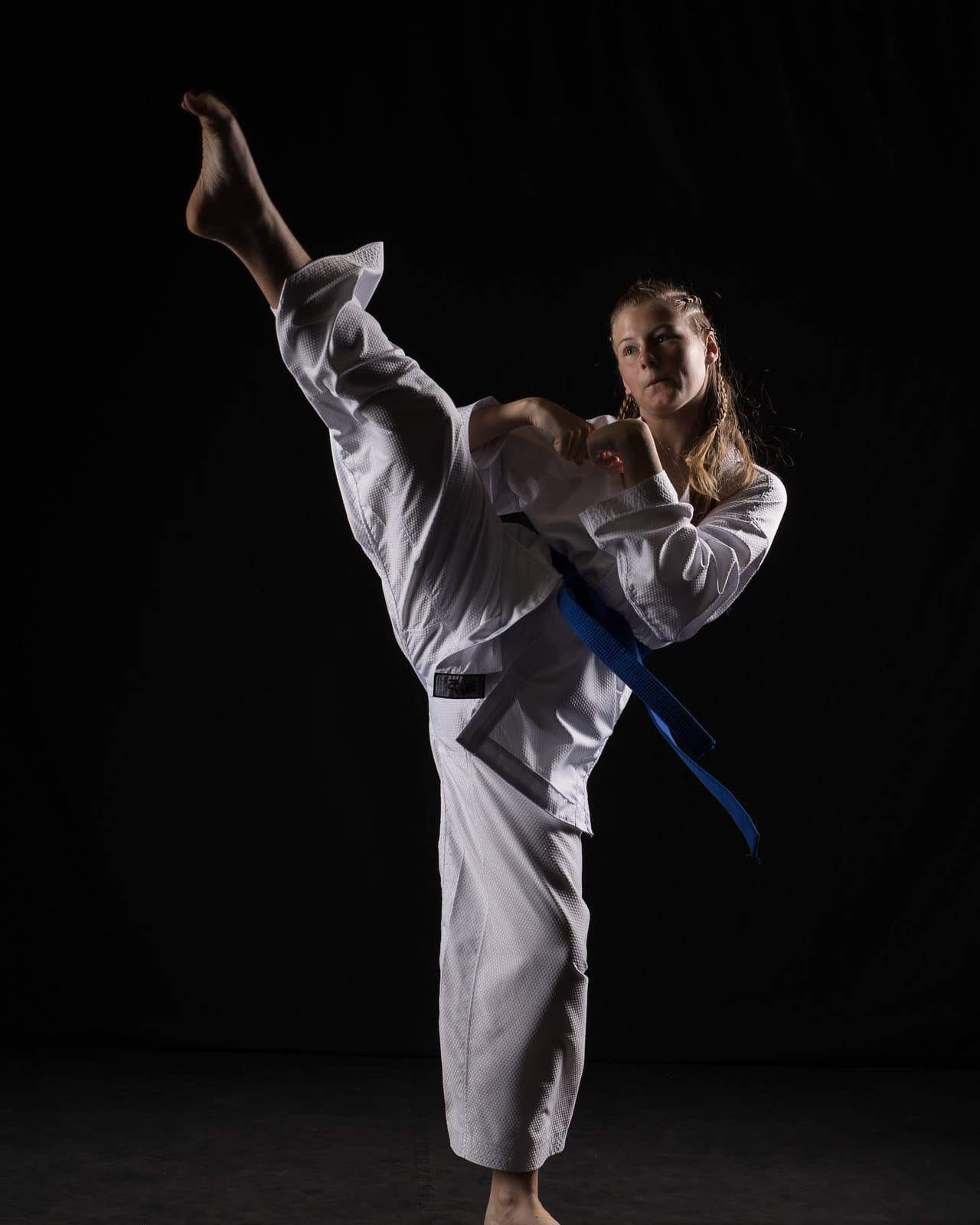 A TKD Juniors student landing a high side kick at Apex Martial Arts, Evesham